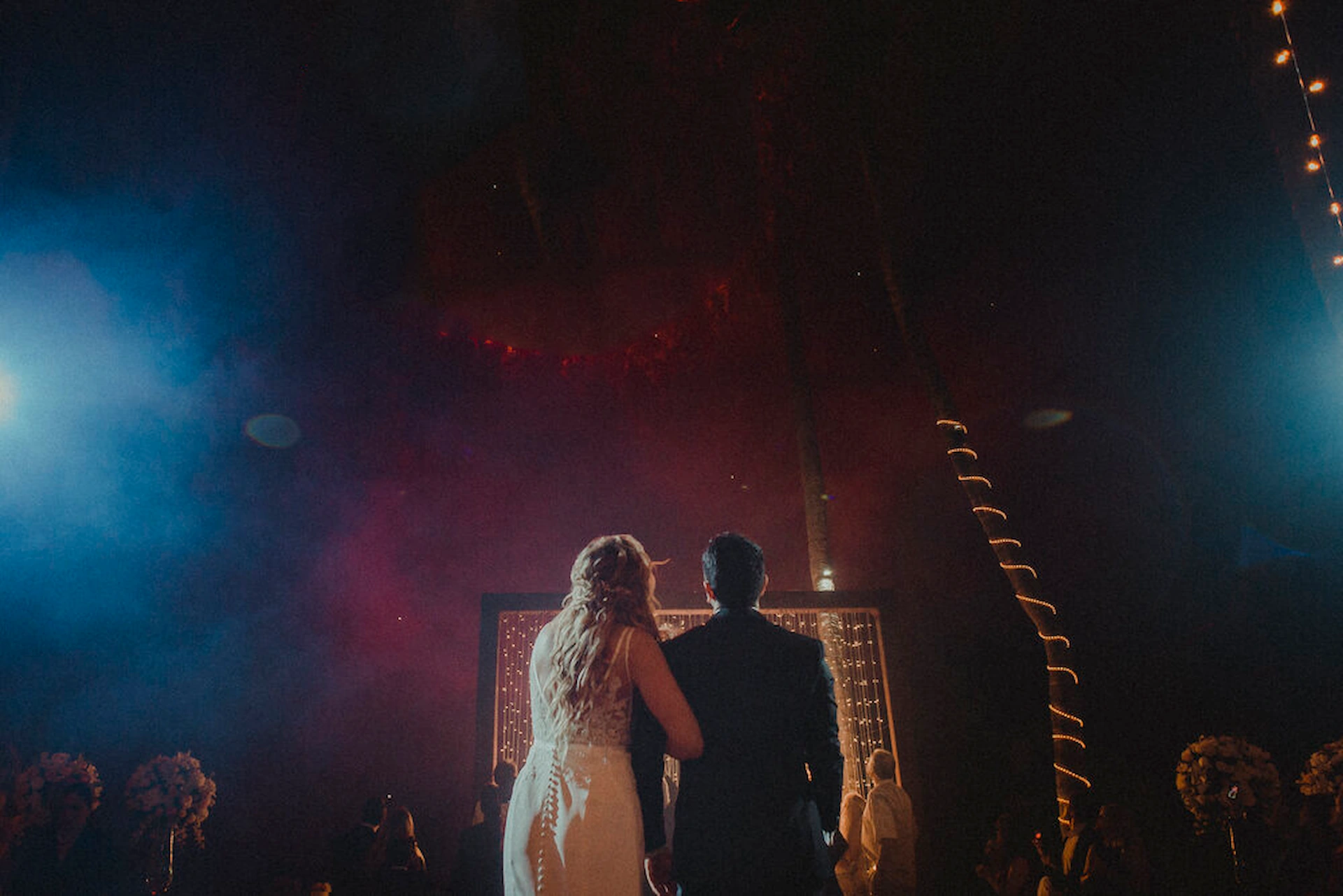 Bride and groom watching the beginning of a drone show at a wedding